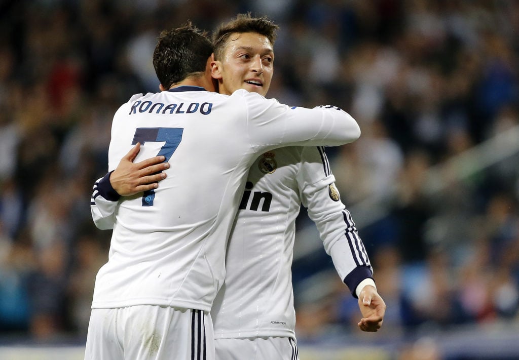 Cristiano Ronaldo embracing Mesut Ozil during a Real Madrid game