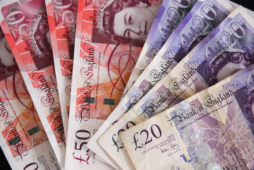 Fifty pounds bank notes are seen in this photo illustration