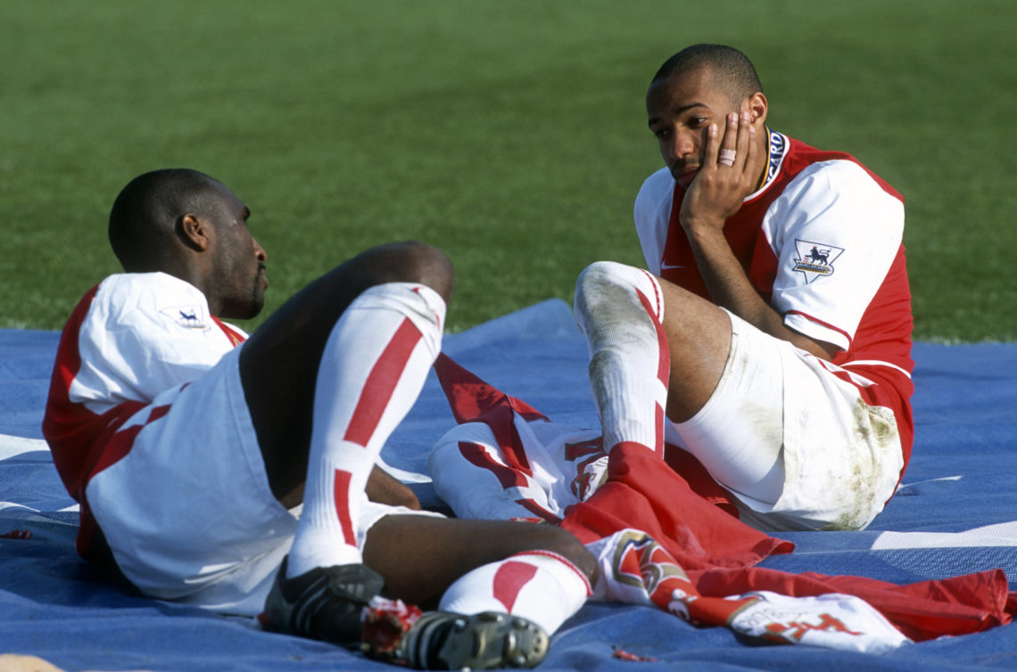 15 May 2004 - Premiership Football - Arsenal v Leicester City - Sol Campbell and Thierry Henry of Arsenal sit on a large Premiership flag and talk ...