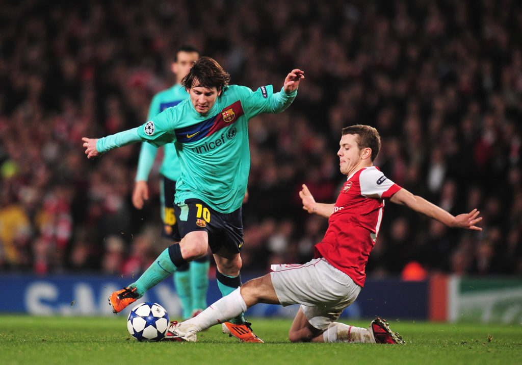 Arsenal academy product Jack Wilshere in action against Lionel Messi of Barcelona in UEFA Champions League