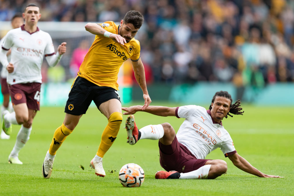 Wolverhampton Wanderers winger Pedro Neto in action v Phil Foden and Nathan Ake of Manchester City in Premier League amid Paul Merson verdict on transfer to Arsenal