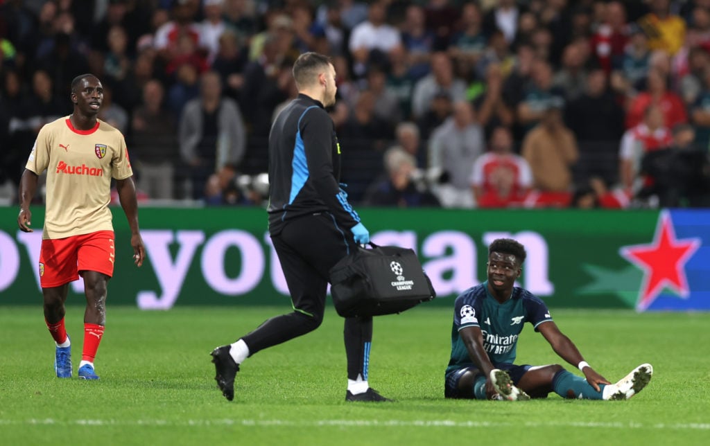 Arsenal winger Bukayo Saka receives treatment for hamstring injury at RC Lens in Group B - UEFA Champions League 2023/24 tie