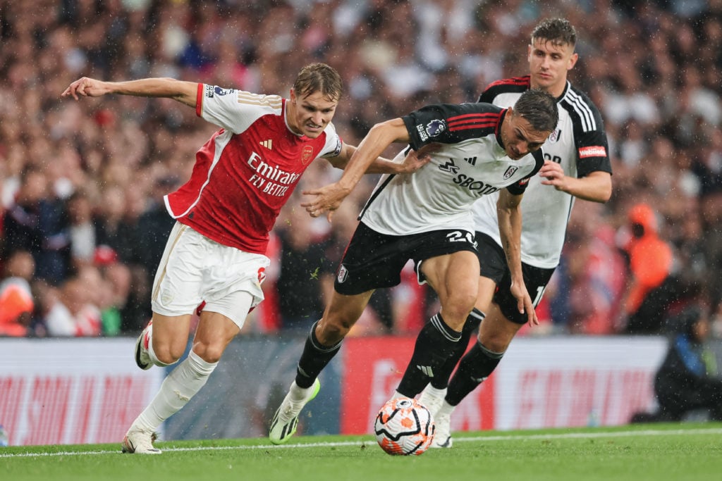 Joao Palhinha challenges Martin Odegaard during Arsenal FC v Fulham FC in the Premier League clash.