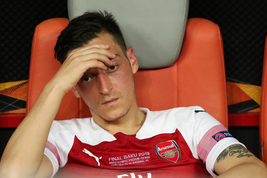 Mesut Ozil looking dejected on the bench during an Arsenal game