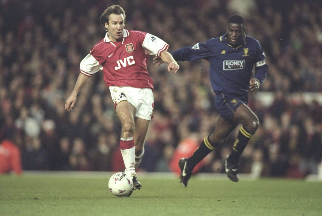 Paul Merson of Arsenal challenged by Robbie Earle