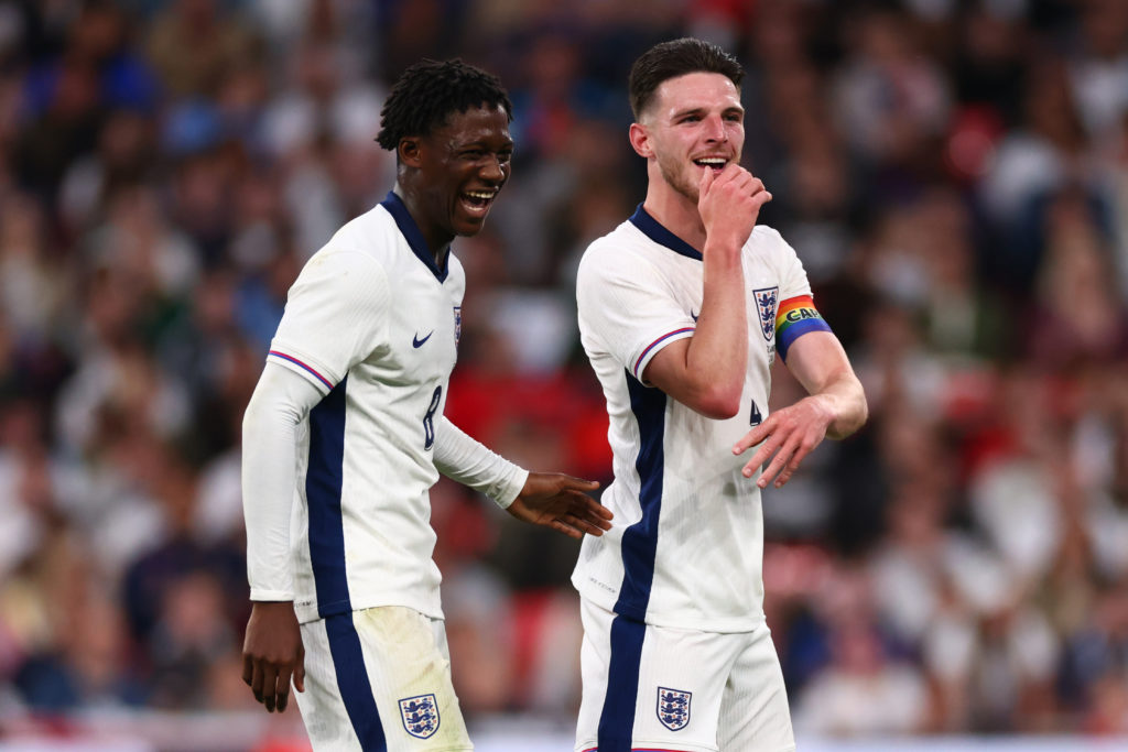 Kobbie Mainoo laughs alongside Declan Rice of England.