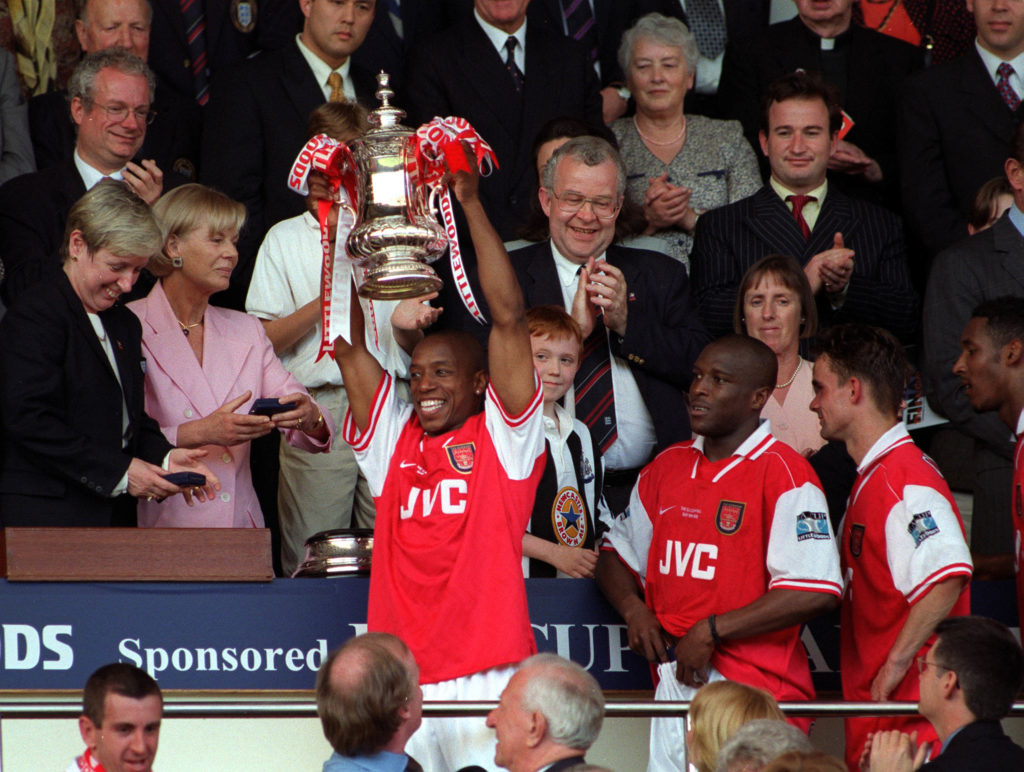 Football. 1998 FA Cup Final. Wembley. 16th May, 1998. Arsenal 2 v Newcastle United 0. Arsenal's Ian Wright proudly holds aloft the trophy in the Royal Box during the presentation as Arsenal complete the Double.