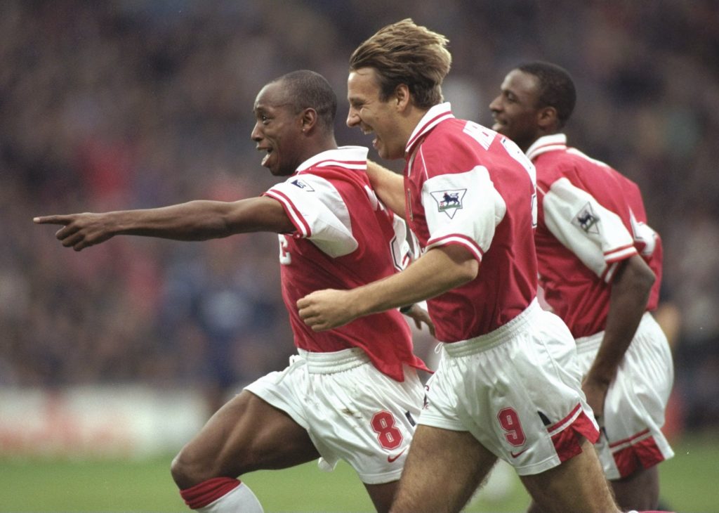 Ian Wright of Arsenal (centre) leads the celebrations with a little help from teammate Paul Merson