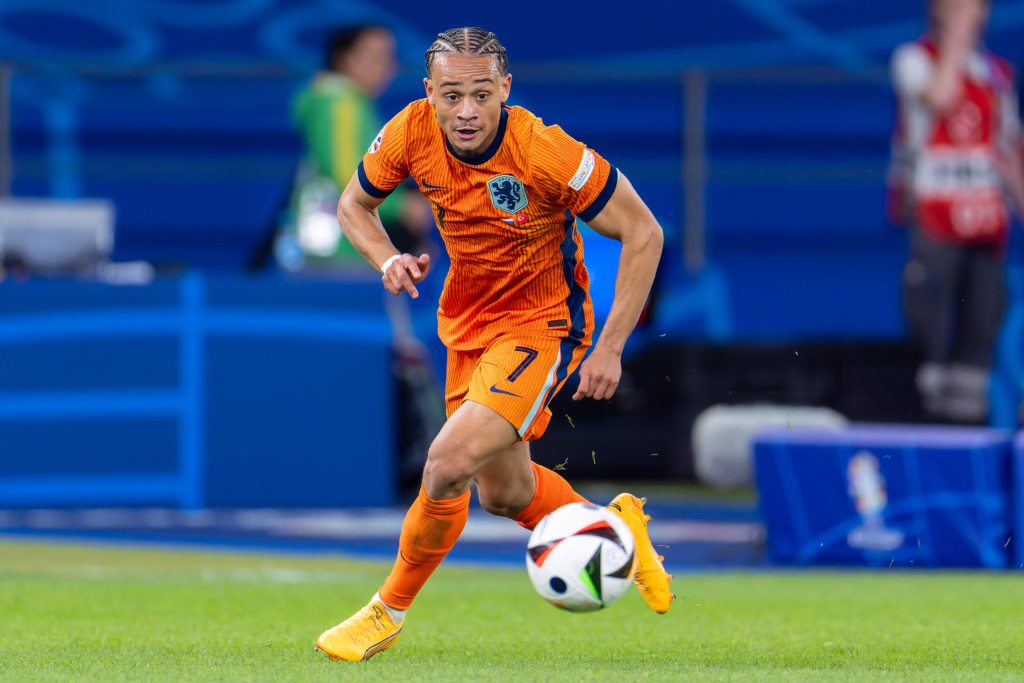 Xavi Simons of the Netherlands runs with the ball during the Quarter-Final - UEFA EURO 2024 match between Netherlands and Turkiye at Olympiastadion on July 6, 2024
