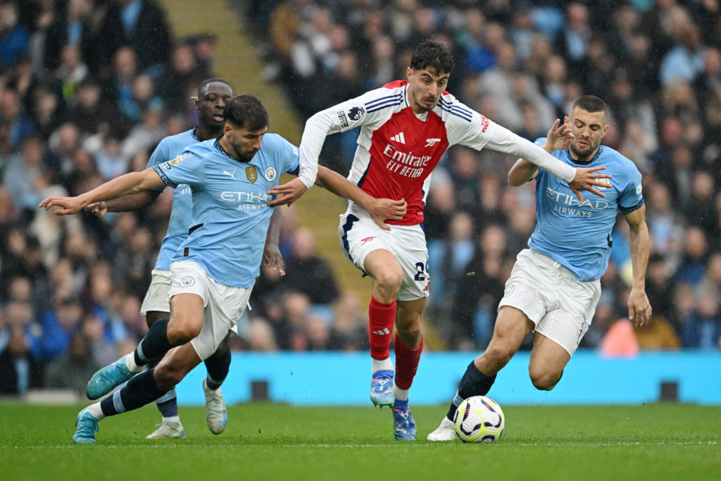 Kai Havertz holds off Ruben Dias during Manchester City FC v Arsenal FC in the Premier League clash.