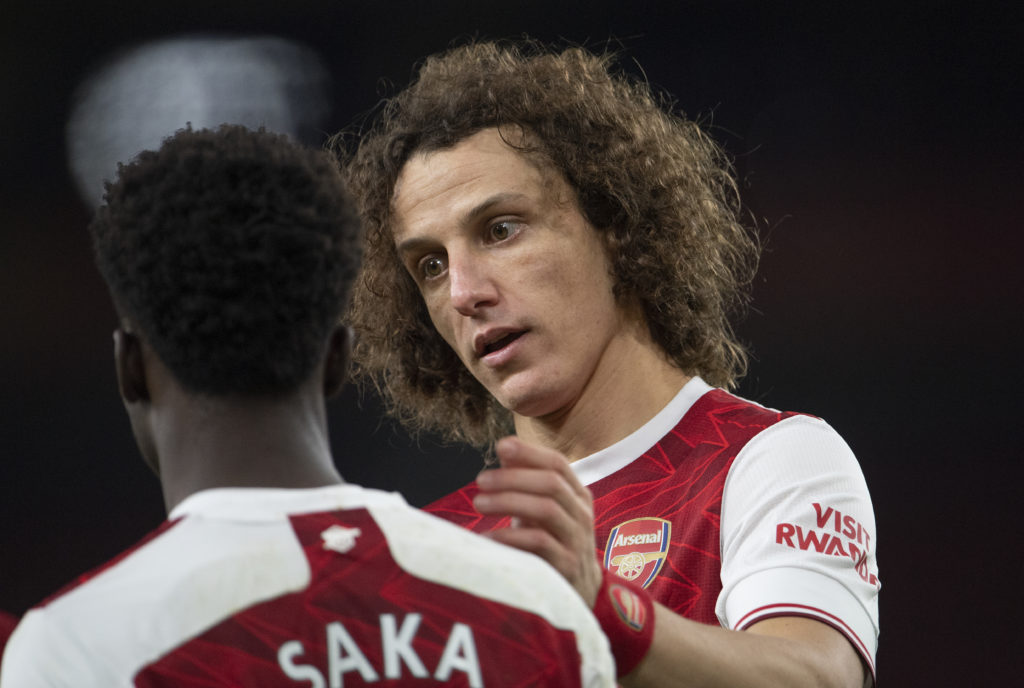 David Luiz embraces Bukayo Saka during an Arsenal game