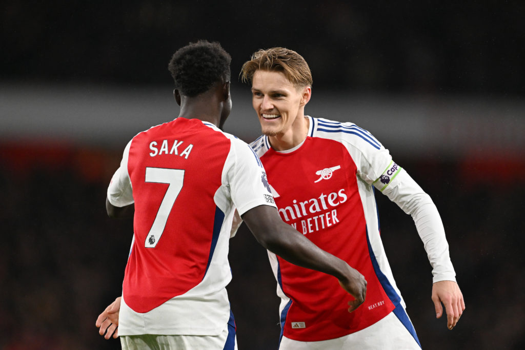 Martin Odegaard and Bukayo Saka embrace during an Arsenal game