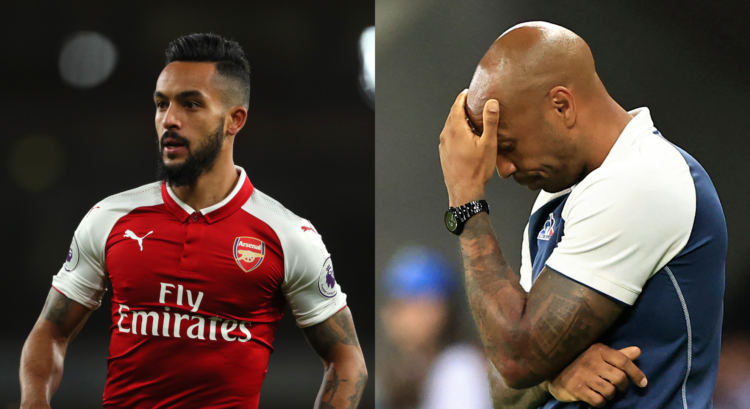 Theo Walcott looks on for Arsenal as Thierry Henry reacts with his hand on his head.