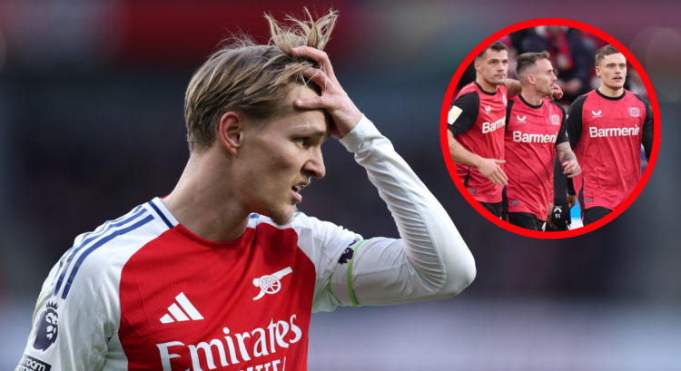 Martin Odegaard of Arsenal looks on as Bayer Leverkusen players celebrate.