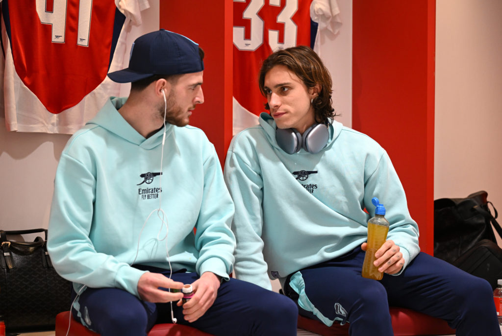 Declan Rice and Riccardo Calafiori speak to each other in the Arsenal dressing room before a game