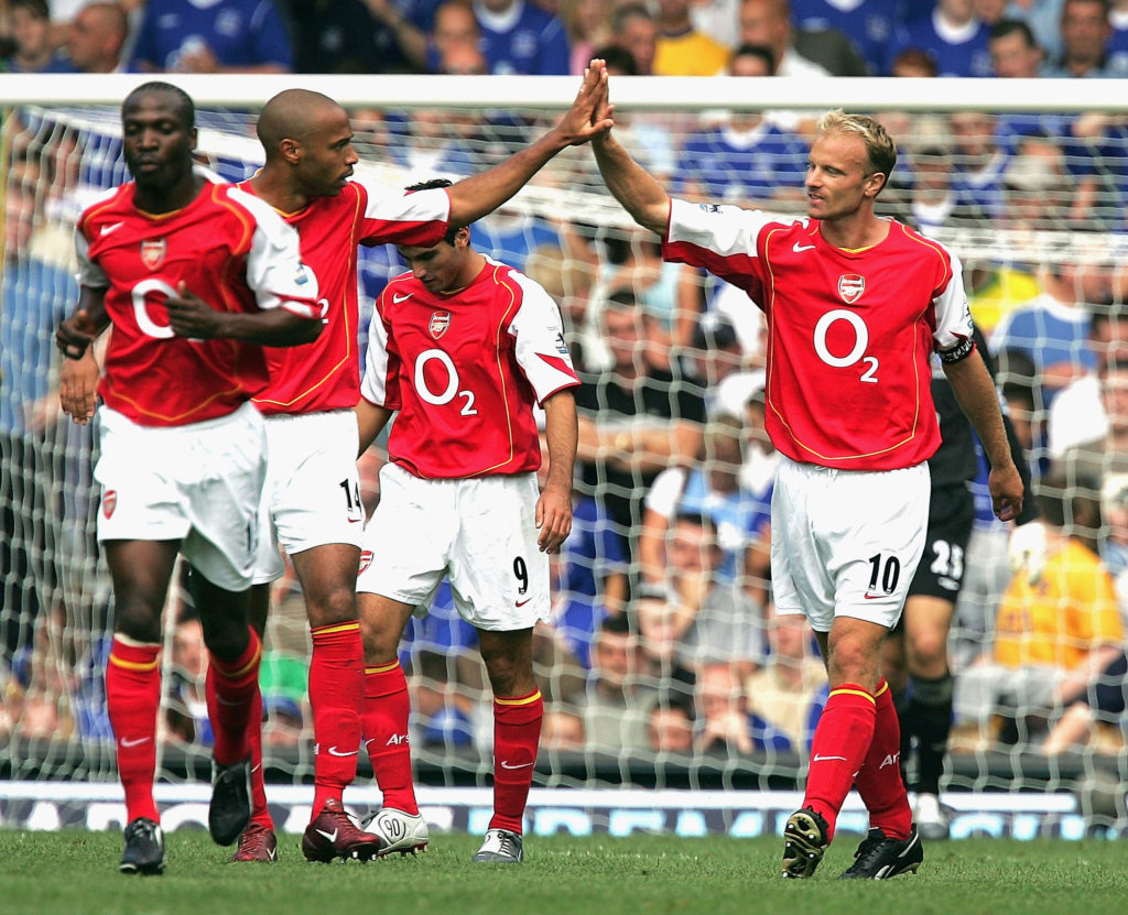 Dennis Bergkamp of Arsenal (R) celebrates with Thierry Henry after scoring the first goal during the Barclays Premiership match between Everton and Arsenal at Goodison Park on August 15, 2004 in Everton, England.
