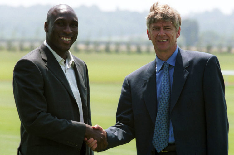 3 Jul 2001:  Sol Campbell (left) shakes hands with manager Arsene Wenger during a press conference at Arsenals training ground, London Colney, to a...