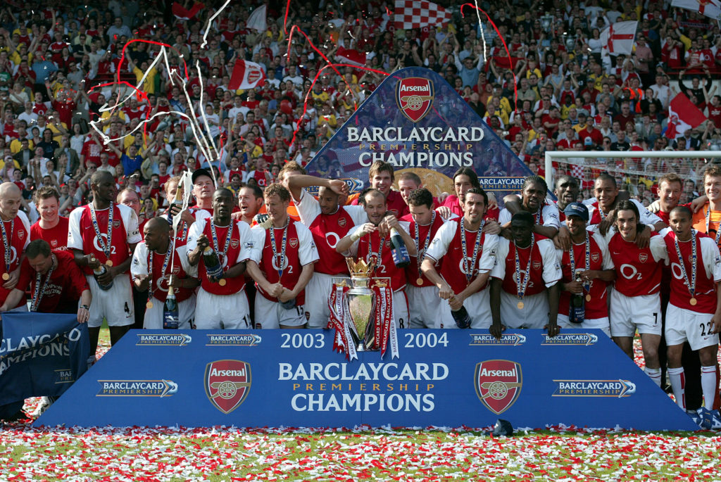 : Arsenal players celebrate with Premiership trophy after becoming the 2003-2004 Premier League champions after winning the Premier League match between Arsenal and Leicester at Highbury on May 15, 2004 in London, England.