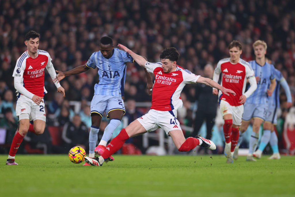 Pape Matar Sarr and Declan Rice clash during Arsenal v Tottenham Hotspur in the Premier League.
