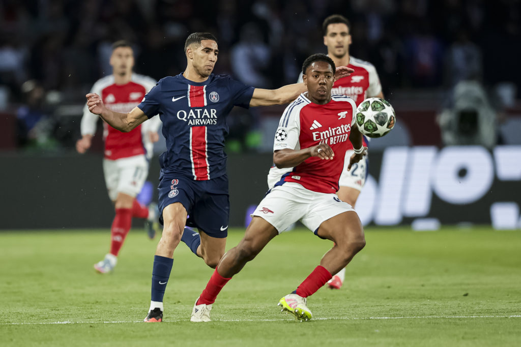 Achraf Hakimi of Paris Saint Germain (L) fights for the ball with Myles Lewis-Skelly of Arsenal FC (R) during the UEFA Champions League 2024/25 Semi Final Second Leg match between Paris Saint-Germain and Arsenal FC at Parc des Princes.