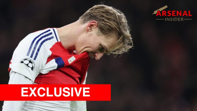 Martin Odegaard reacts during the UEFA Champions League match between Arsenal and AS Monaco with the Arsenal Insider exclusive banner.