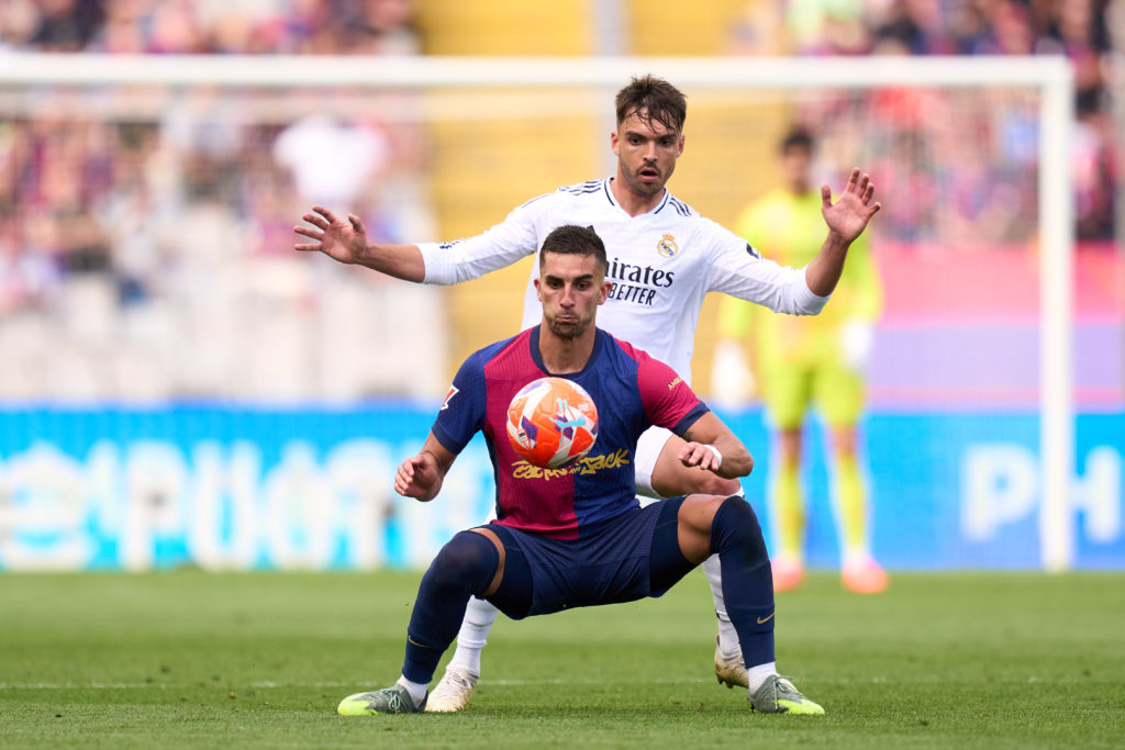Ferran Torres is challenged by Raul Asencio during FC Barcelona v Real Madrid CF in the La Liga EA Sports clash.