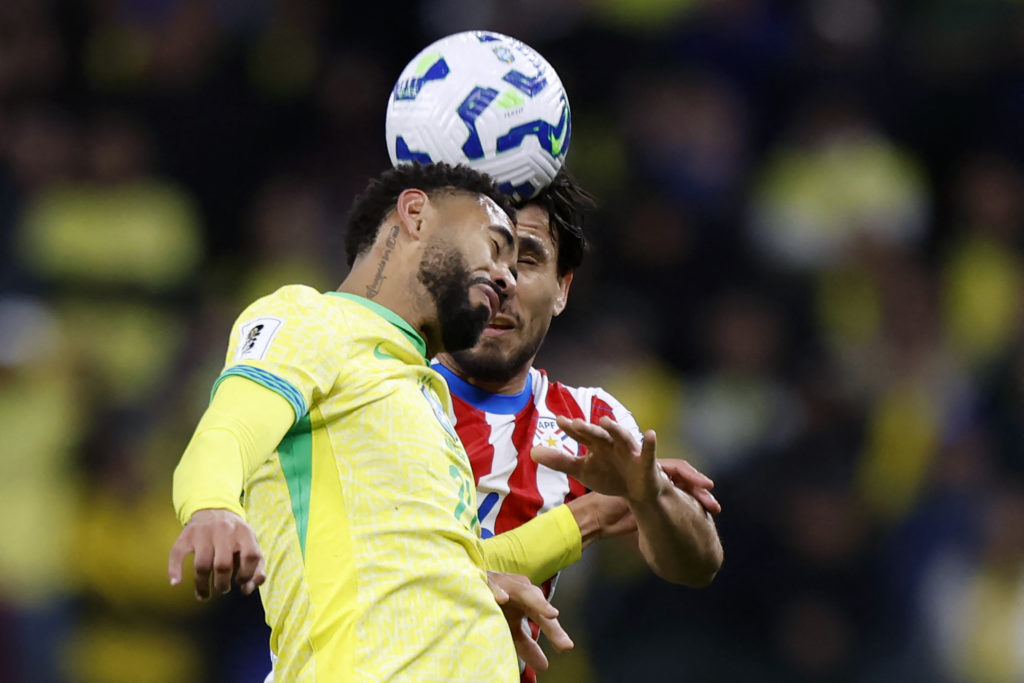 Matheus Cunha heads the ball during Brazil's match with Paraguay