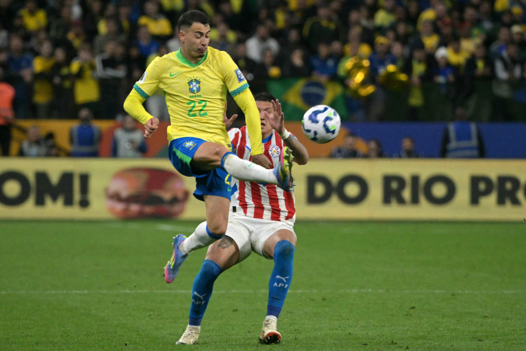 Gabriel Martinelli jumps to control the ball during a game between Brazil and Paraguay