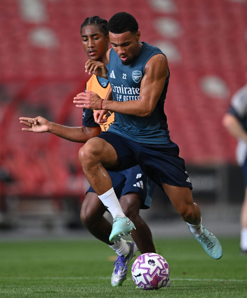 Ethan Nwaneri running with the ball past Marli Salmon during an Arsenal training session