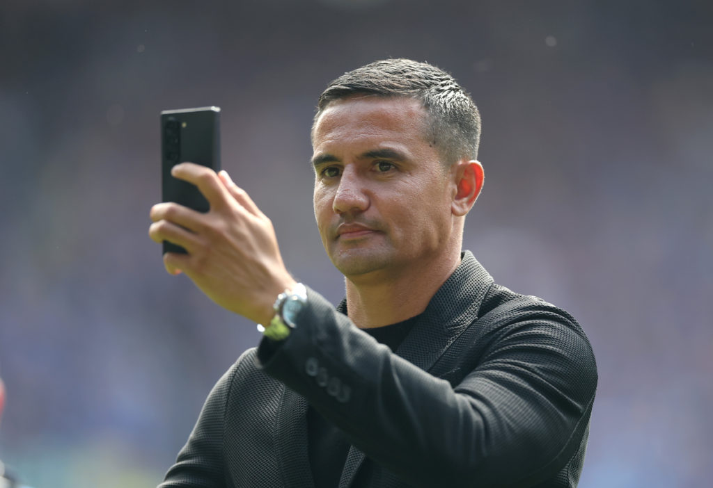 Tim Cahill holds up his phone during a lap of honour at Goodison Park.