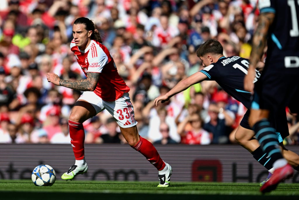 Riccardo Calafiori of Arsenal runs with the ball whilst under pressure from Mikel Jauregizar of Athletic Club during the pre-season friendly match between Arsenal and Athletic Club at Emirates Stadium on August 09, 2025