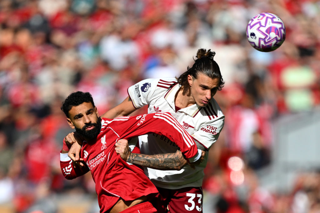 Riccardo Calafiori of Arsenal challenges Mohamed Salah for the ball
