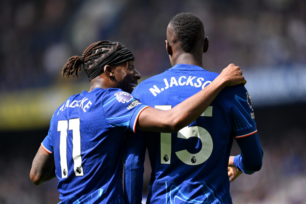 Noni Madueke and Nicolas Jackson speaking to each other during a Chelsea game