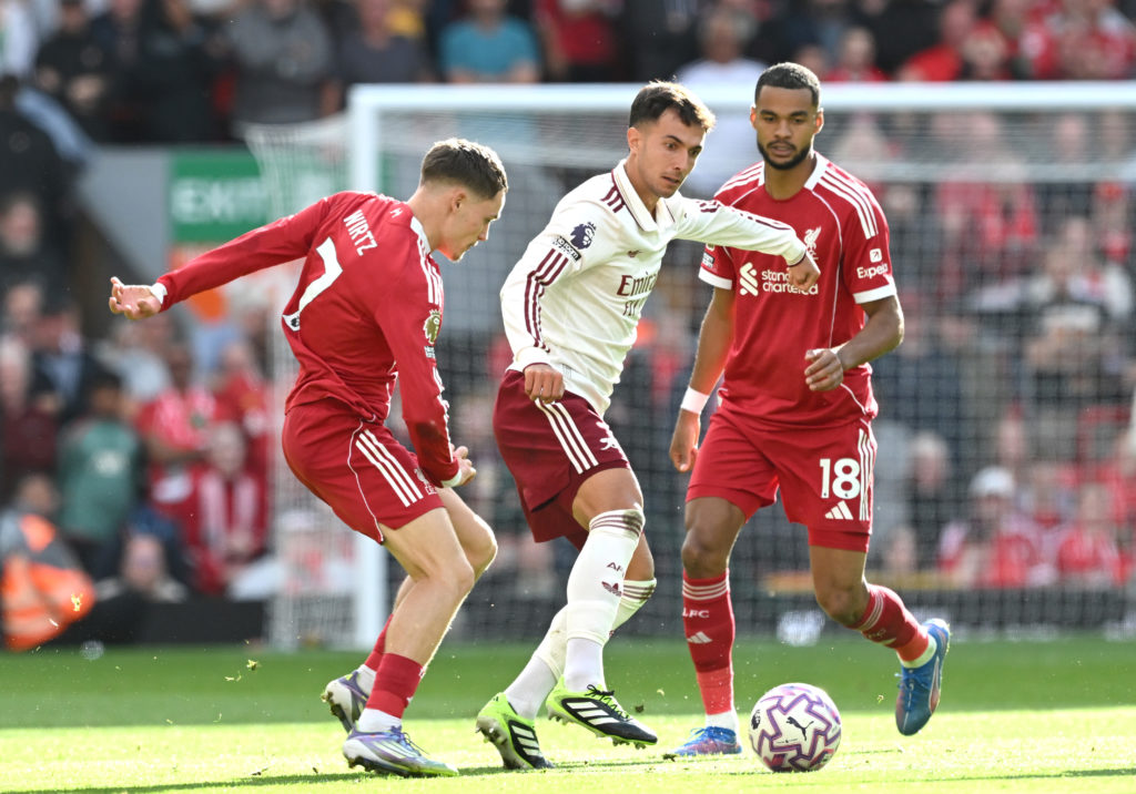 Martin Zubimendi of Arsenal is put under pressure by Florian Wirtz and Cody Gakpo of Liverpool during the Premier League match between Liverpool and Arsenal at Anfield on August 31, 2025 in Liverpool, England.