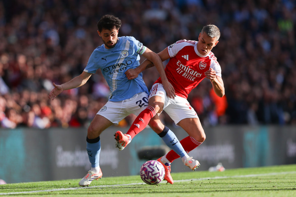 Bernardo Silva of Manchester City battles for possession with Leandro Trossard of Arsenal during the Premier League match between Arsenal and Manchester City.