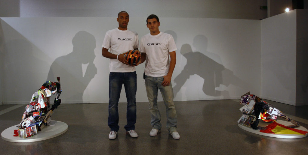 Thierry Henry (and Madrid's goalkeeper Iker Casillas pose, 20 September 2007 in Barcelona, in front of their shadows created by original sculptures made up of personal objects reflecting their tastes and lifestyle as part of a sponsor's promotional event