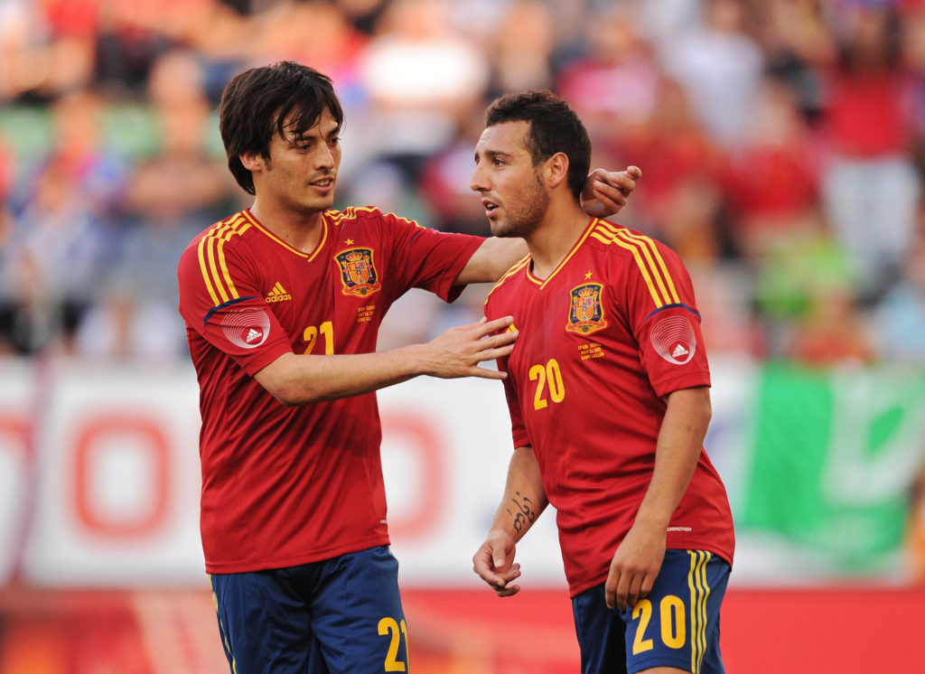 Santi Cazorla and David Silva embrace during a Spain game