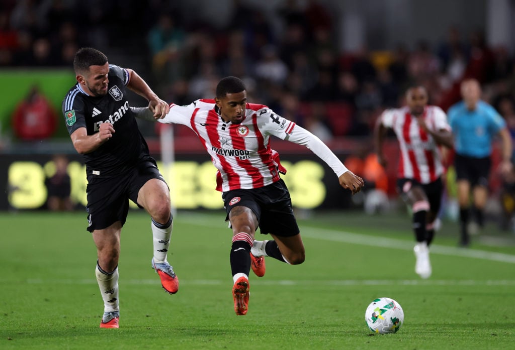 Reiss Nelson of Brentford is is challenged by John McGinn of Aston Villa during the Carabao Cup Third Round match between Brentford and Aston Villa.