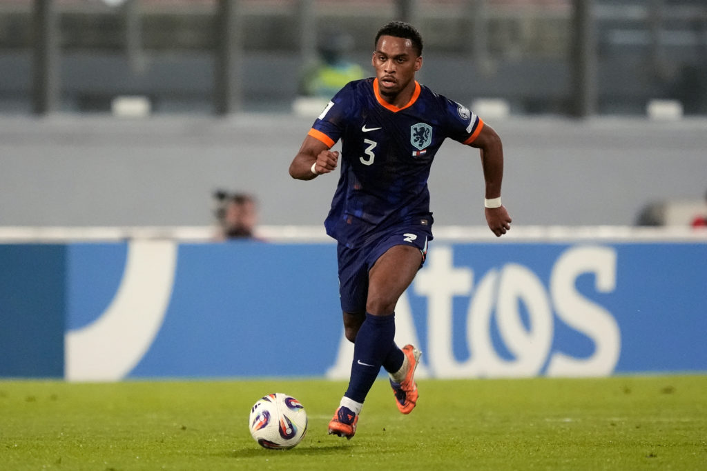 Jurrien Timber runs forward with the ball during a Netherlands game