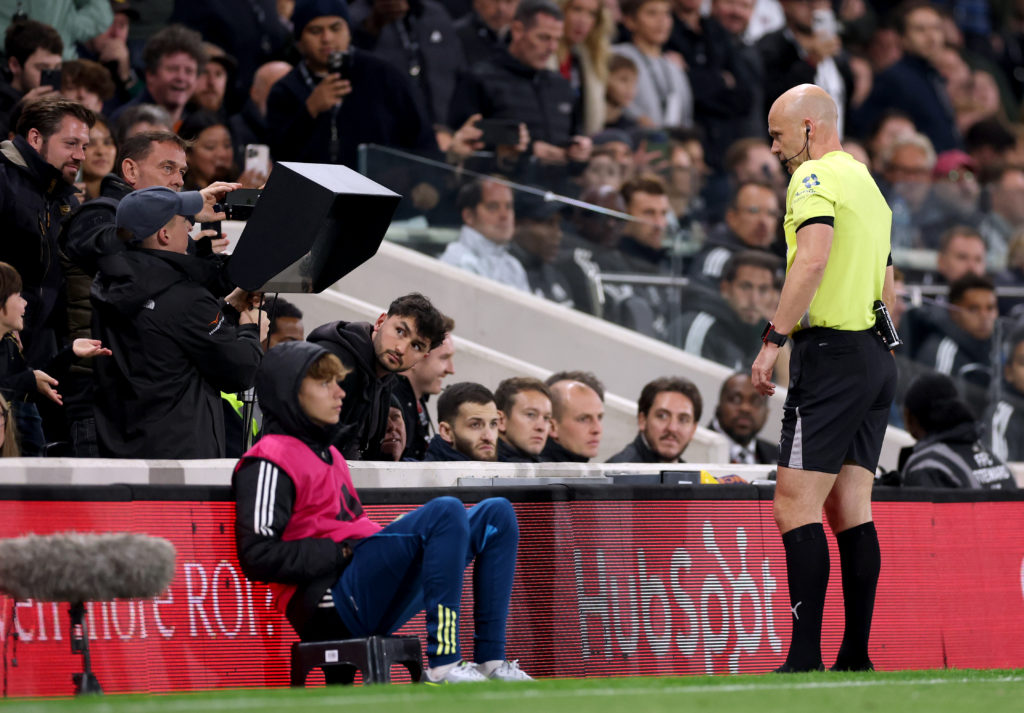 Referee Anthony Taylor looks at teh VAR monitor during an Arsenal game