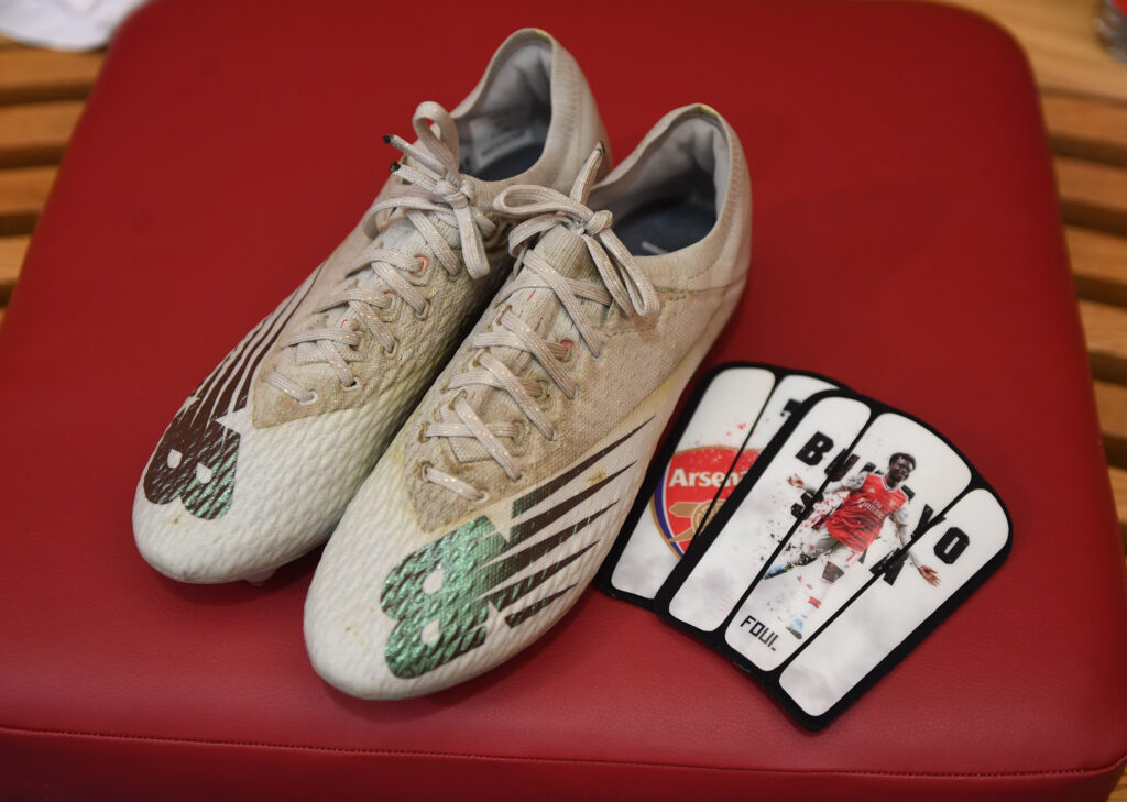 Bukayo Saka's New Balance boots and shinpads in the Arsenal changing room