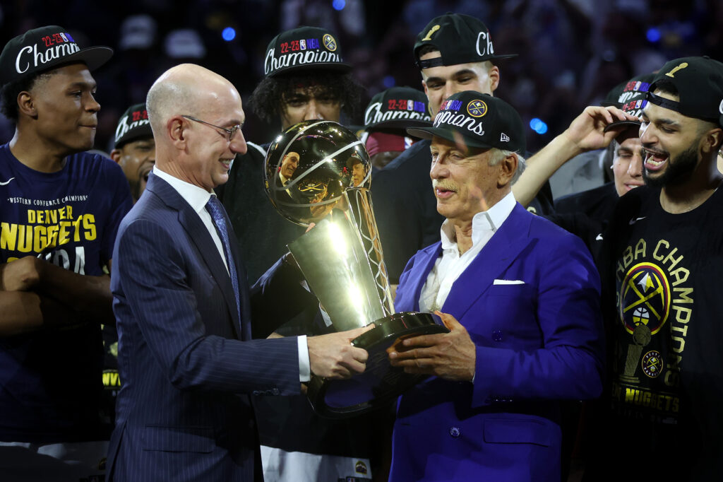 Arsenal owner Stan Kroenke is handed the NBA Championship trophy in his role as Denver Nuggets owner