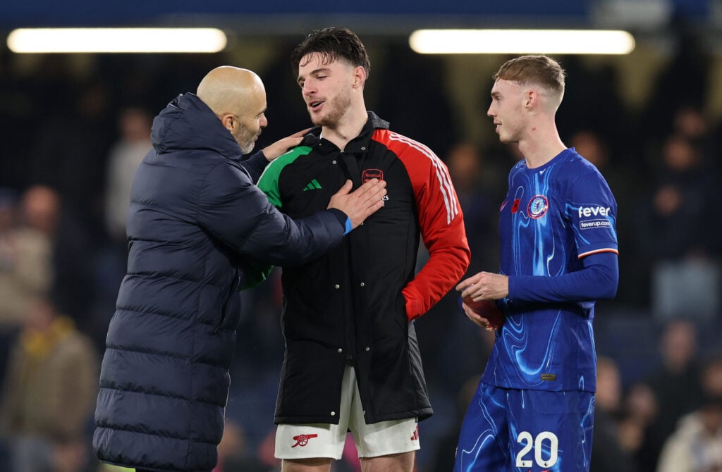 Enzo Maresca speaks to Declan Rice as Cole Palmer looks on after a game between Chelsea and Arsenal