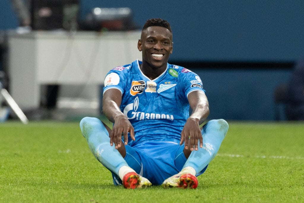 Luiz Henrique smiling while sitting on the pitch during a Zenit St Petersburg game