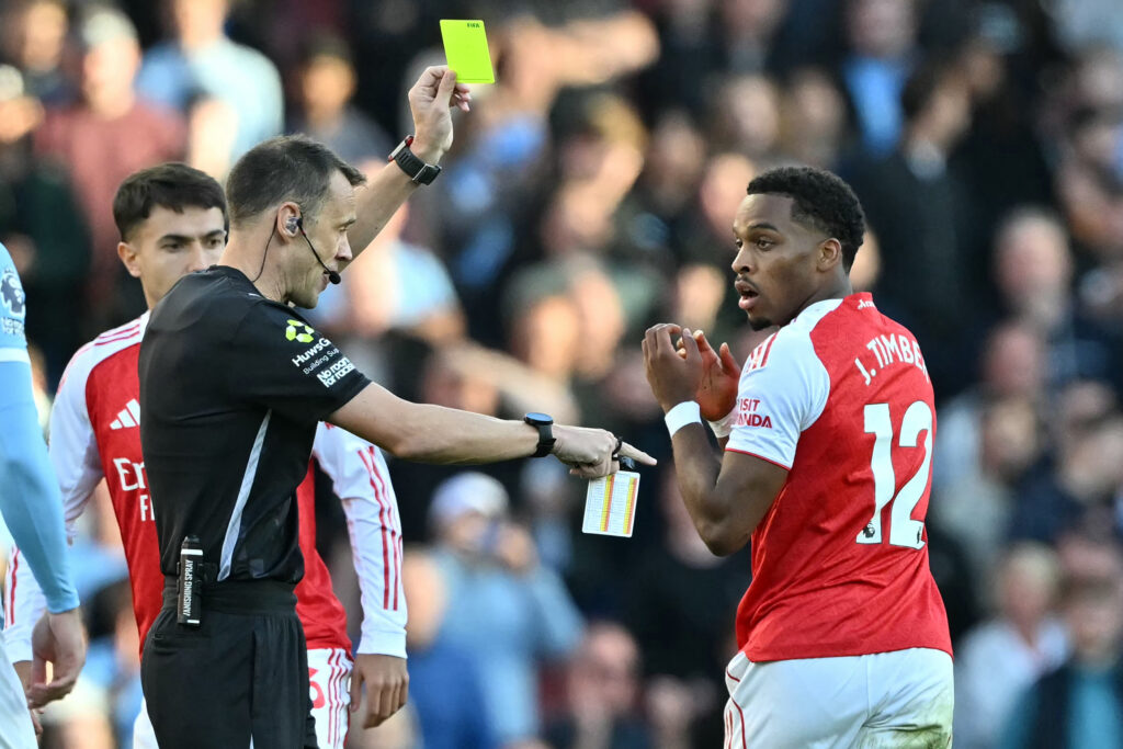 Jurrien Timber is shown a yellow card for Arsenal against Manchester City