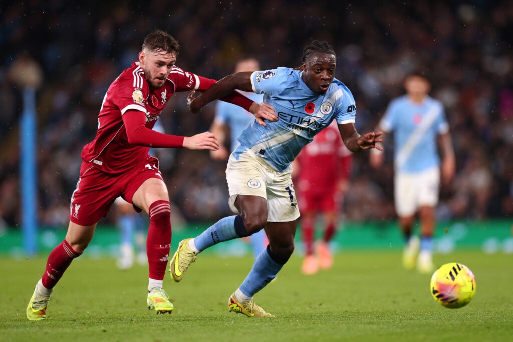 Jeremy Doku and Conor Bradley compete for the ball during Man City vs Liverpool
