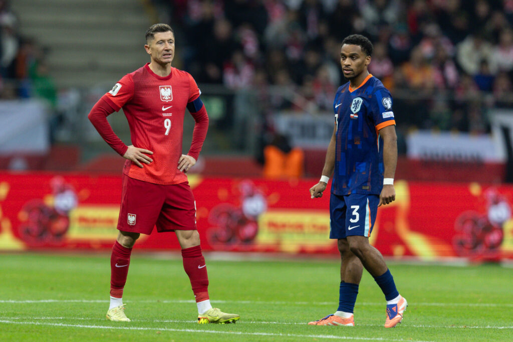 Robert Lewandowski and Jurrien Timber look on during Poland vs Netherlands