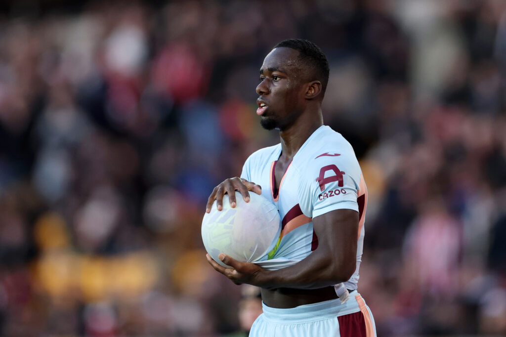 Michael Kayode dries the ball with his shirt before a throw in