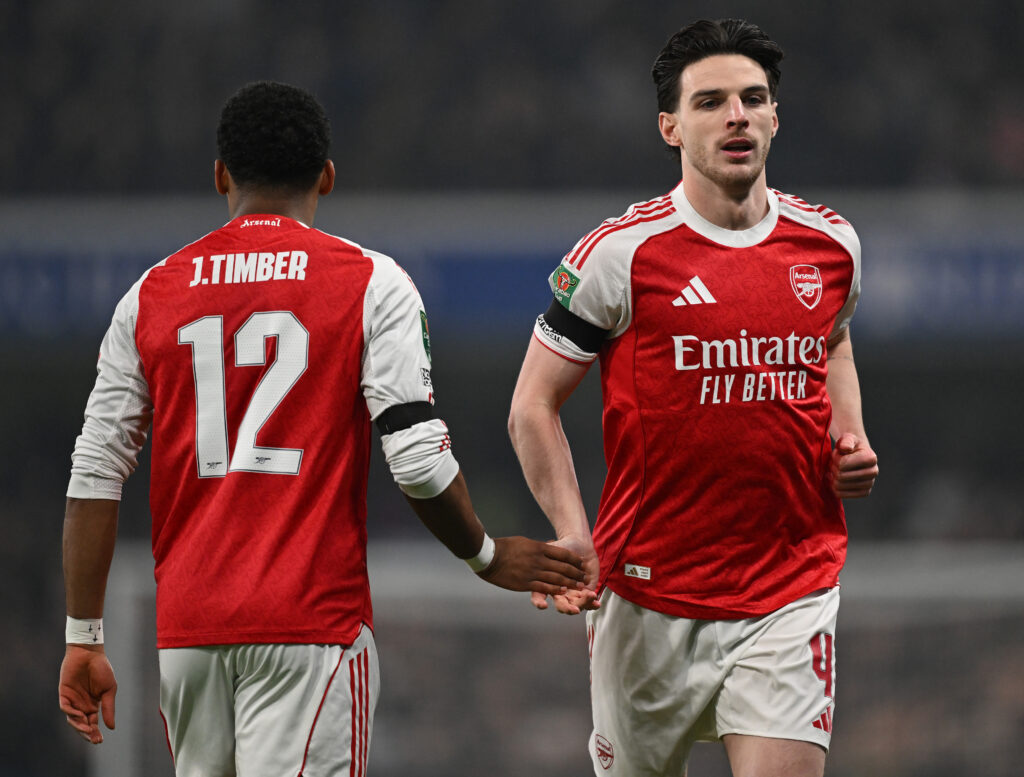 Declan Rice shakes hands with Jurrien Timber during an Arsenal game