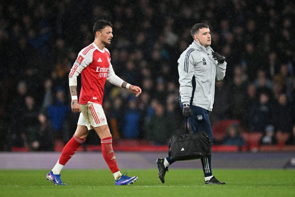 Ben White of Arsenal walks off with Simon Murphy, physiotherapist of Arsenal during the Emirates FA Cup Fourth Round match between Arsenal and Wigan Athletic.